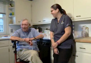 staff talking to a senior in the kitchen